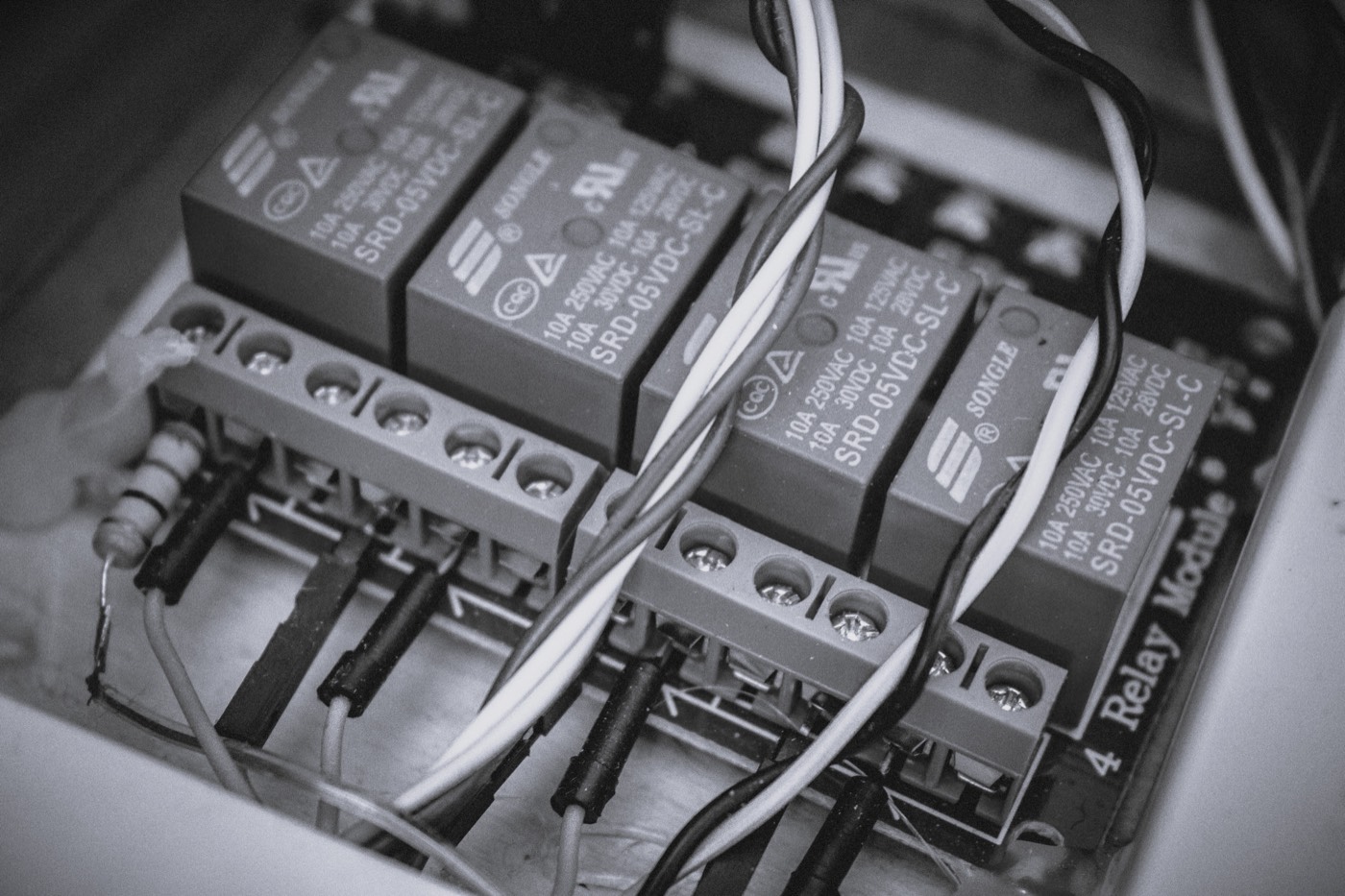 Close-up of relay modules and wiring on a circuit board.